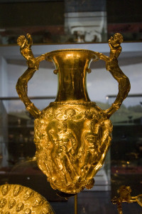 The Panagyurishte Treasure golden amphora. The big amphora has handles shaped as centaurs, and the openings for pouring wine represent Negro heads. Inbetween those two opinings, the amphora is decorated with a scene of Hercules fighting a snake.
